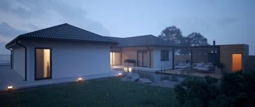 Moderní bungalov s osvětlenými okny večer