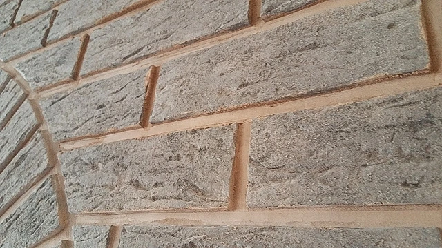 Detailní pohled na zdivo z klinkerových cihel s viditelnými švy.