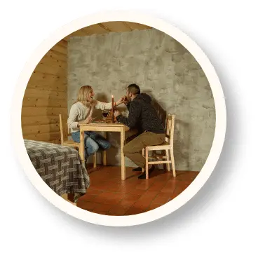 People at wooden table inside earth house